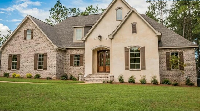 french country style house featuring a front lawn