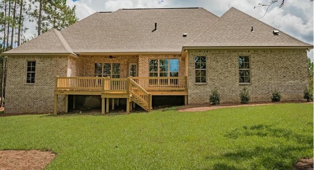 back of property featuring a yard and a wooden deck