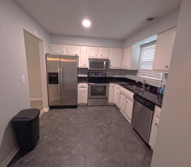 kitchen featuring sink, white cabinets, and stainless steel appliances