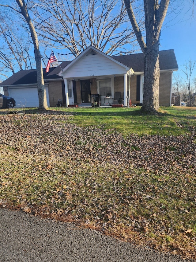 ranch-style home with a front yard and a garage