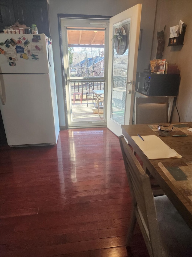 dining space with dark hardwood / wood-style floors