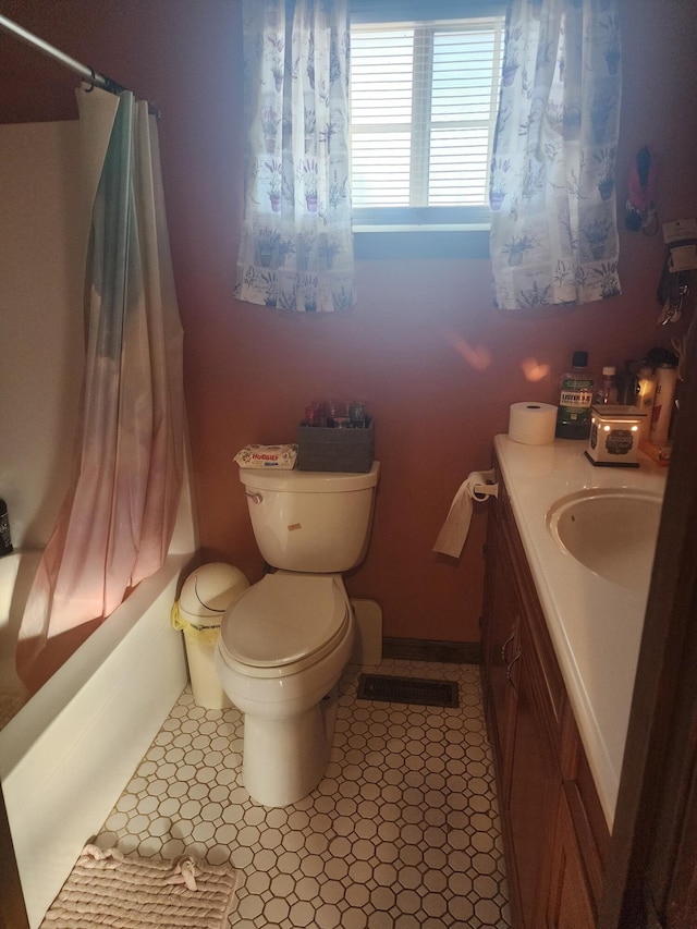 full bathroom featuring toilet, vanity, shower / tub combo with curtain, and tile patterned flooring