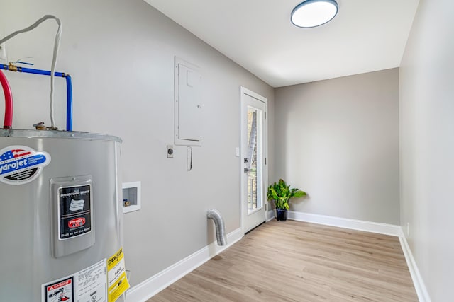 clothes washing area featuring electric water heater, light hardwood / wood-style flooring, washer hookup, and hookup for an electric dryer