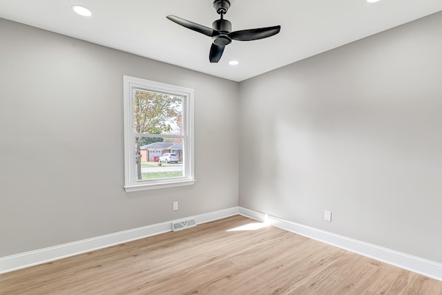 spare room with ceiling fan and light wood-type flooring