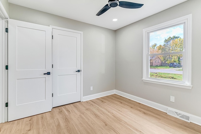 unfurnished bedroom with ceiling fan and light hardwood / wood-style floors