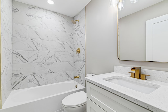 full bathroom featuring vanity, toilet, and tiled shower / bath