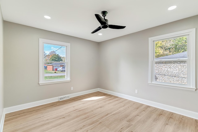 spare room featuring light hardwood / wood-style floors and ceiling fan