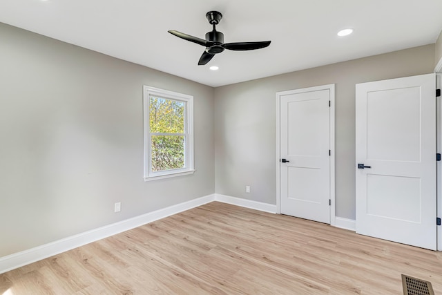 unfurnished bedroom with ceiling fan and light hardwood / wood-style floors