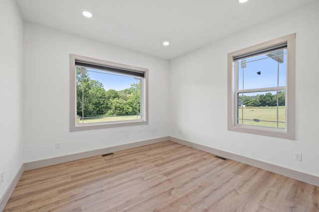 unfurnished room with light wood-type flooring