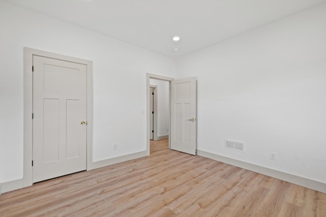 empty room with light hardwood / wood-style flooring