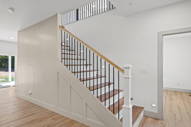 staircase with hardwood / wood-style flooring