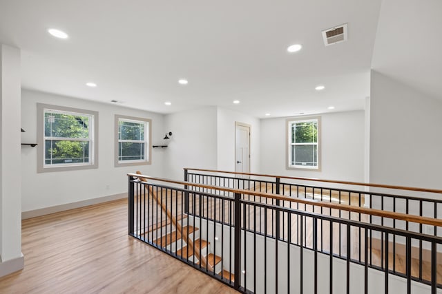 hallway with light hardwood / wood-style floors