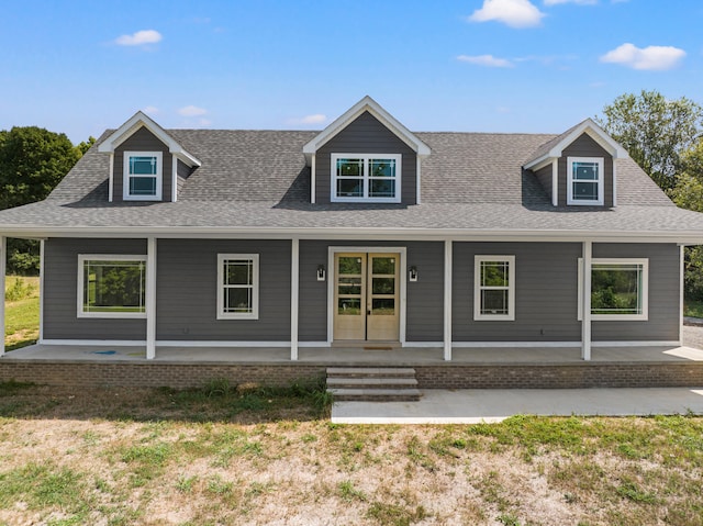 new england style home with a porch and a front yard