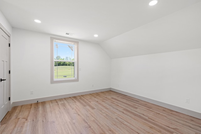 bonus room featuring light hardwood / wood-style flooring and vaulted ceiling