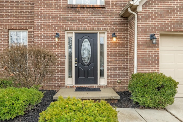 doorway to property with a garage