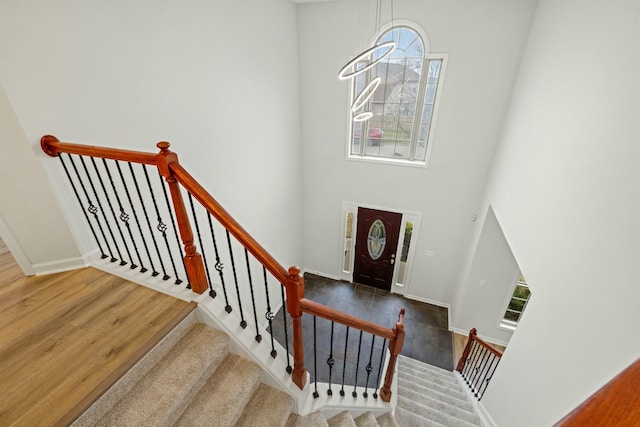 entrance foyer with dark wood-type flooring and a high ceiling