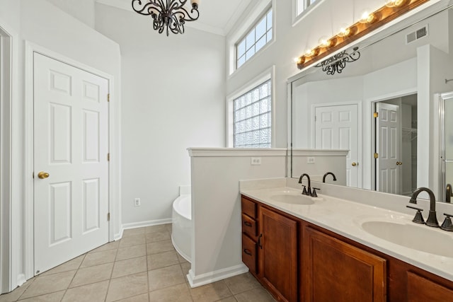 bathroom with ornamental molding, vanity, a bath, an inviting chandelier, and tile patterned flooring