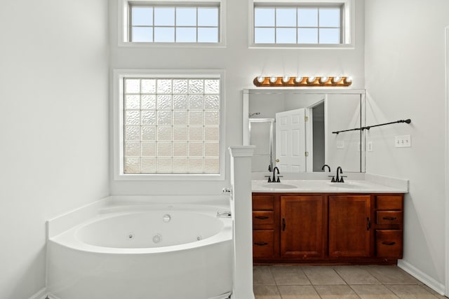 bathroom featuring tile patterned flooring, vanity, and shower with separate bathtub