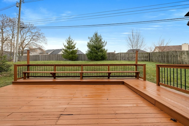 wooden terrace featuring a yard