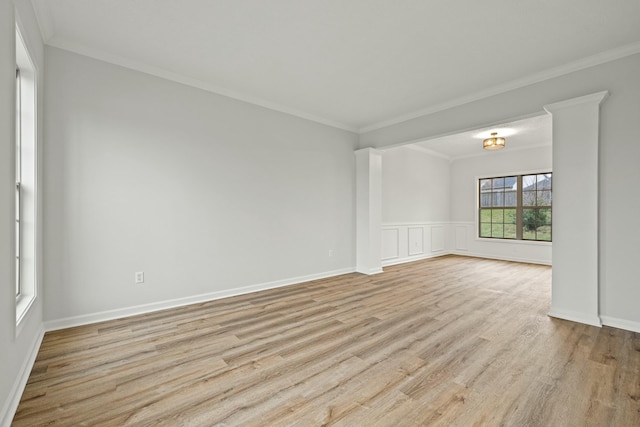 spare room with crown molding and light wood-type flooring