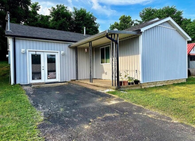 view of front of house with a front lawn and french doors