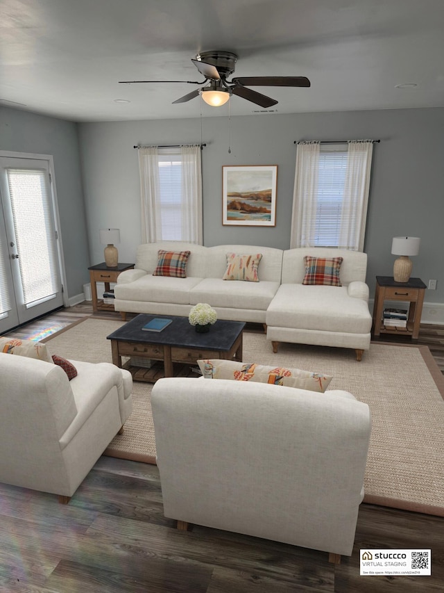 living room with ceiling fan and dark hardwood / wood-style flooring