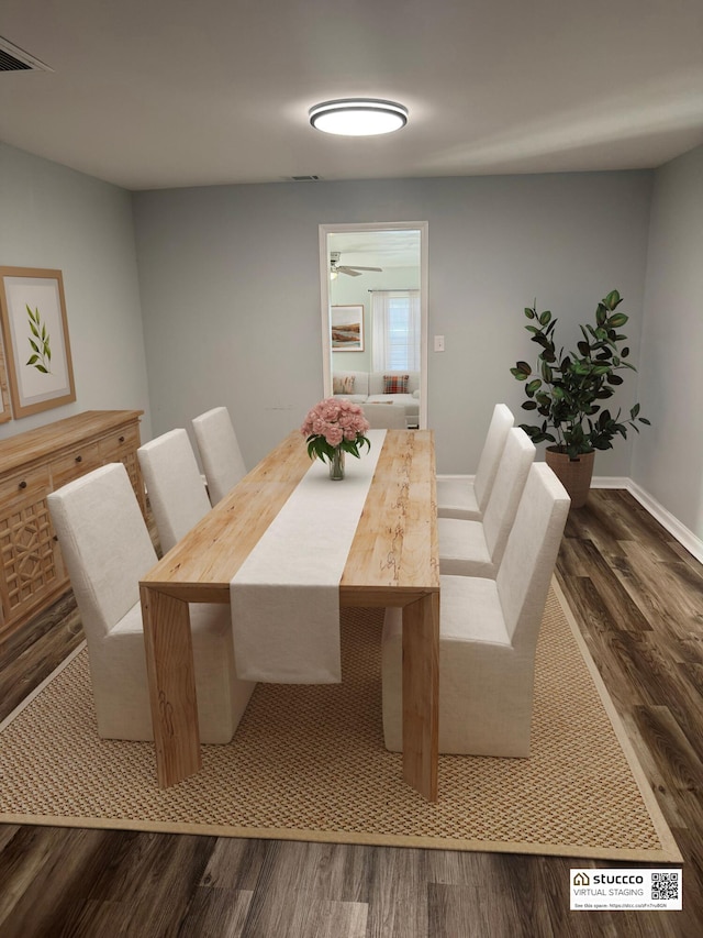 dining area featuring dark wood-type flooring