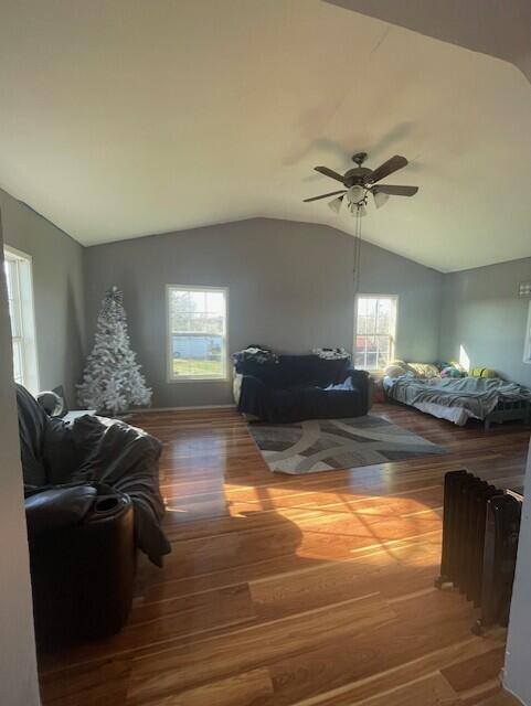 bedroom featuring hardwood / wood-style floors, ceiling fan, and vaulted ceiling