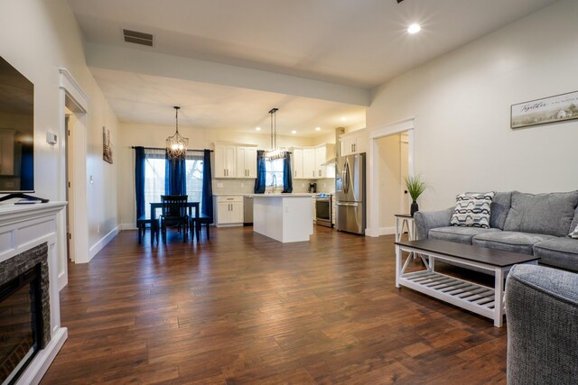 living room with a fireplace and dark hardwood / wood-style floors