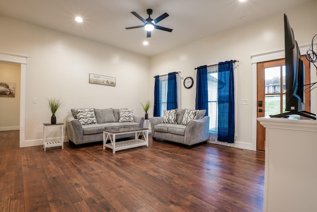 living room with ceiling fan and dark hardwood / wood-style flooring