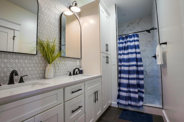 bathroom featuring decorative backsplash, wood-type flooring, vanity, and walk in shower