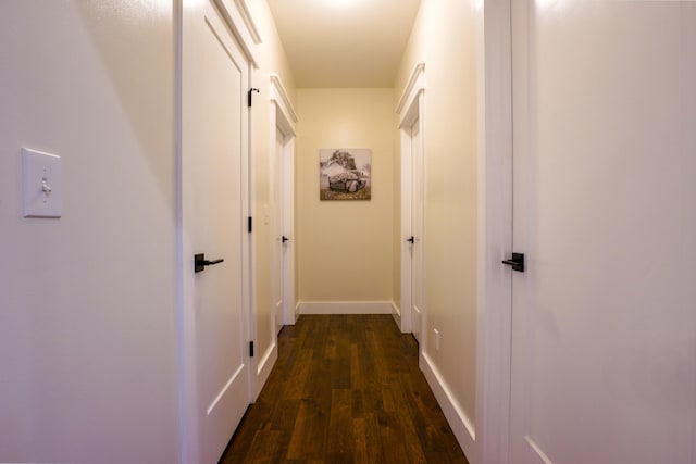 hallway with dark hardwood / wood-style floors