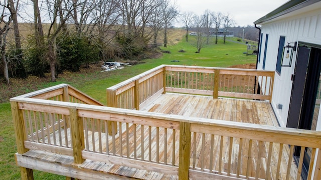 wooden deck featuring a lawn