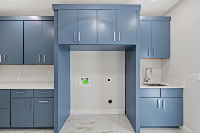 laundry area featuring electric dryer hookup, hookup for a washing machine, sink, and cabinets