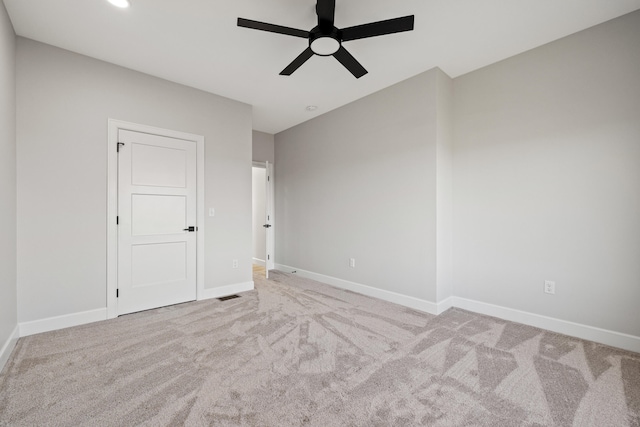 unfurnished room featuring light carpet and ceiling fan