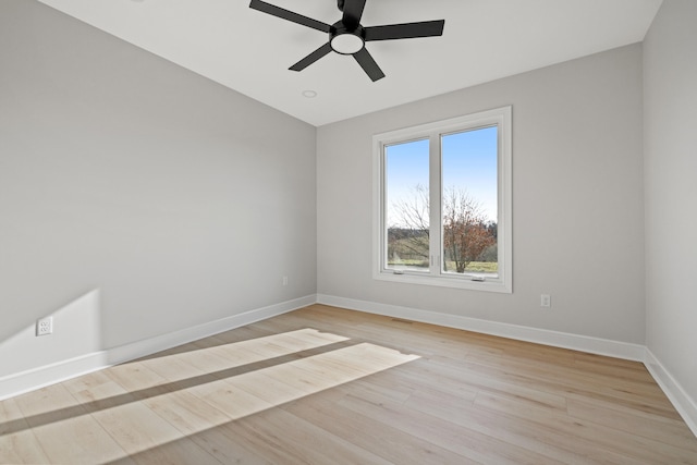 empty room with ceiling fan and light hardwood / wood-style flooring