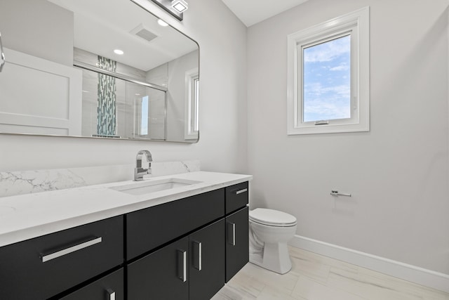 bathroom featuring vanity, toilet, and an enclosed shower