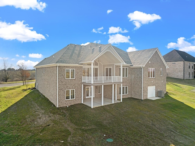 back of house with a balcony, cooling unit, a patio area, a yard, and a garage