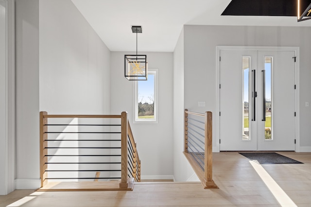 foyer featuring a chandelier and light wood-type flooring