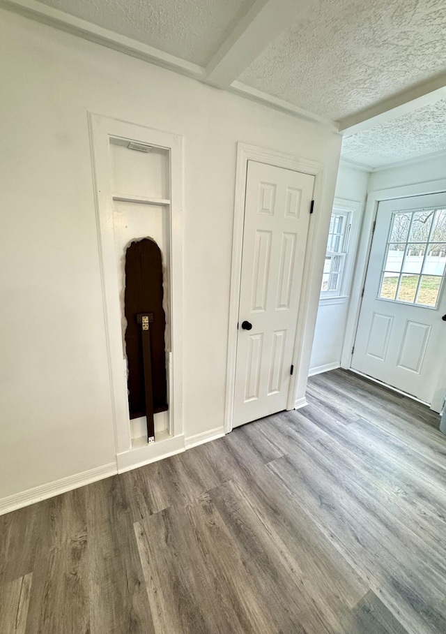 unfurnished bedroom with hardwood / wood-style floors and a textured ceiling