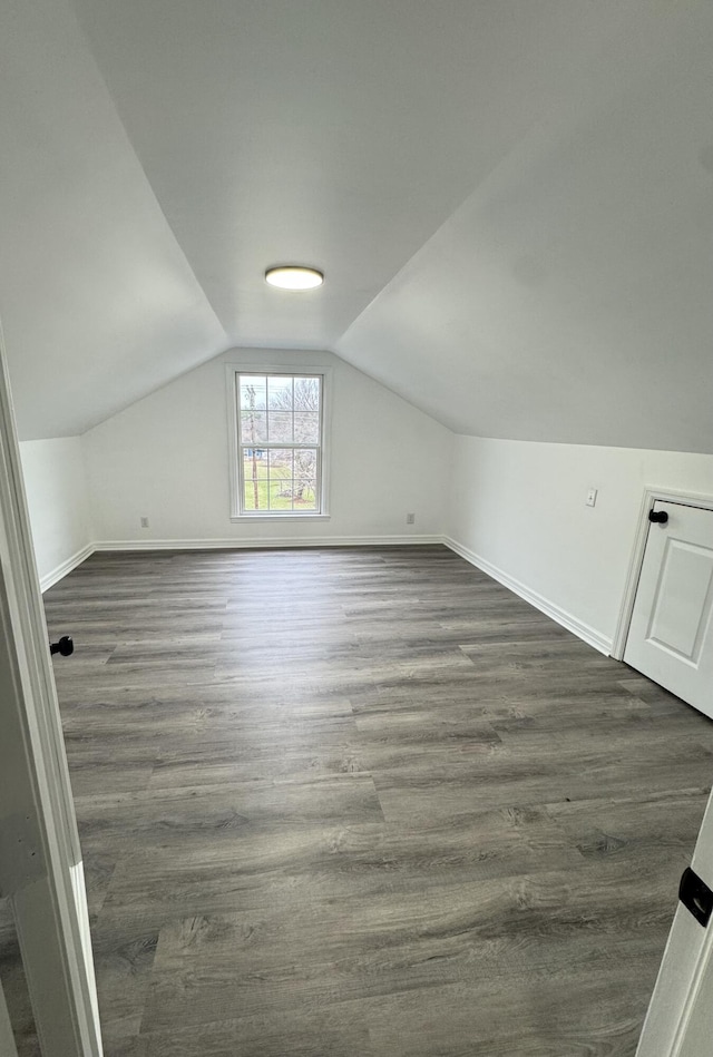 bonus room featuring dark hardwood / wood-style flooring and lofted ceiling