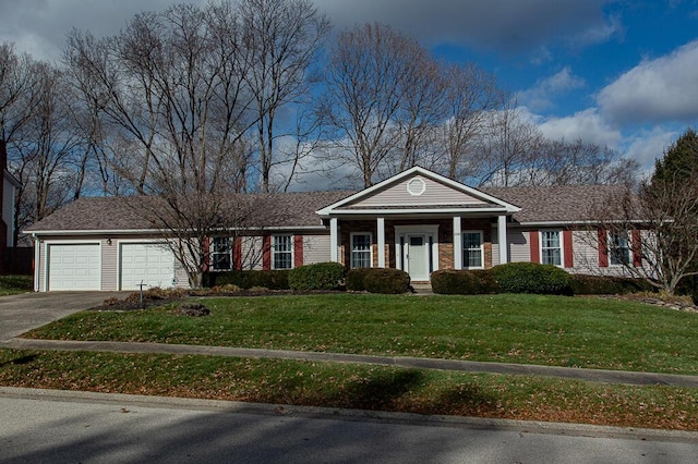 greek revival inspired property with a front yard, a porch, and a garage