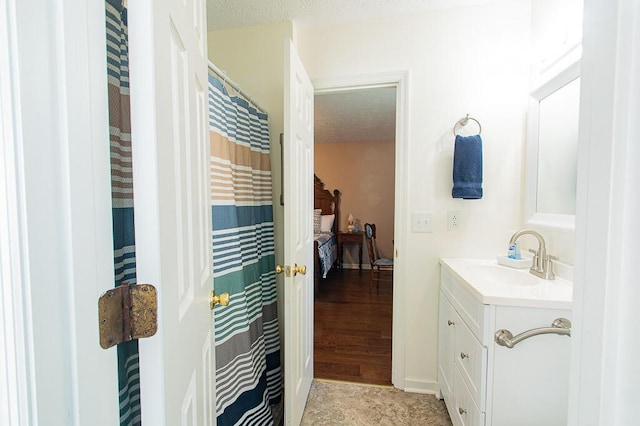 bathroom with vanity and a textured ceiling