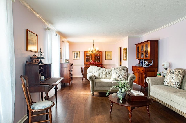 living room with a textured ceiling, a notable chandelier, ornamental molding, and dark wood-type flooring