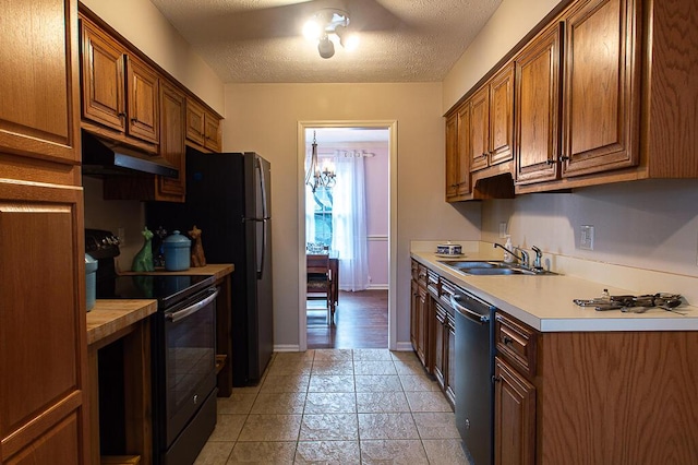 kitchen featuring a textured ceiling, sink, and black appliances