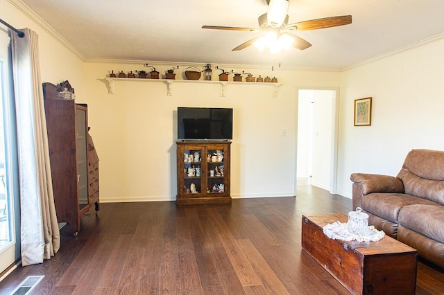 living room with dark hardwood / wood-style floors, ceiling fan, and ornamental molding