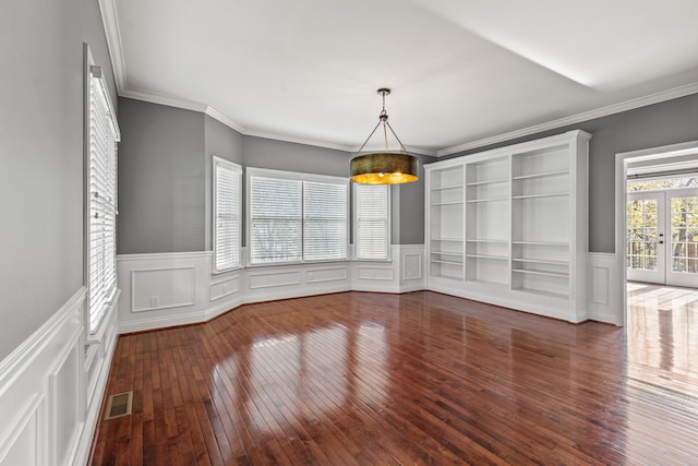 unfurnished dining area with dark hardwood / wood-style flooring, french doors, and ornamental molding