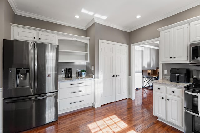 kitchen with light stone countertops, white cabinetry, stainless steel appliances, and dark wood-type flooring