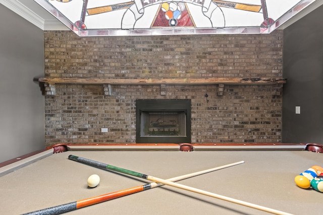 recreation room with a fireplace, ornamental molding, and pool table