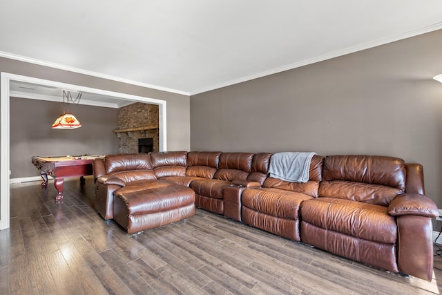 living room with hardwood / wood-style floors, a brick fireplace, ornamental molding, and pool table